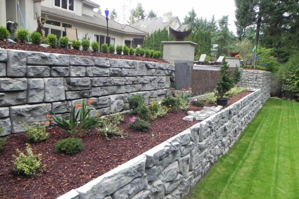 homeguide dry stacked stone retaining wall in backyard